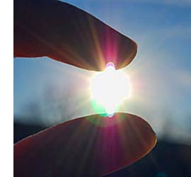 image of finger and thumb positioned as if holding the sun